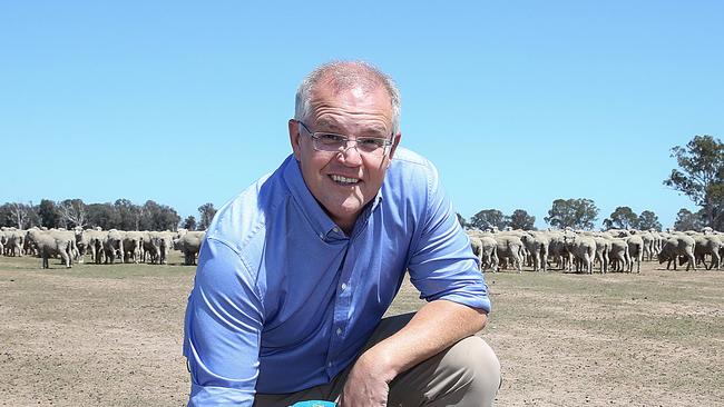 Prime Minister Scott Morrison visiting Briagolong in Gippsland , Victoria to speak with farmers about the effects of on going drought in the region.The Prime Minister inspects the dry earth on the property of sheep farmer John Freeman. Picture : Ian Currie