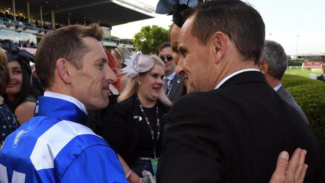 Jockey Hugh Bowman (left) and trainer Chris Waller embrace after Winx won her third Cox Plate. Picture: AAP