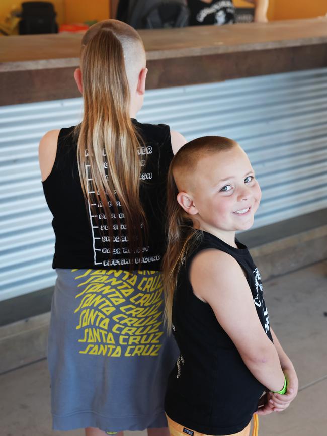 Dylan and Leonardo Mitchell. Who needs a tape measure when you’ve got a shirt to measure the gloriousness of your mullet? Picture: Rohan Kelly