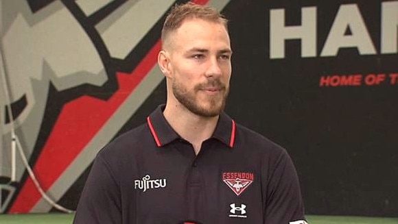 Ben McKay in red and black. Photo: Twitter, @7NewsMelbourne.