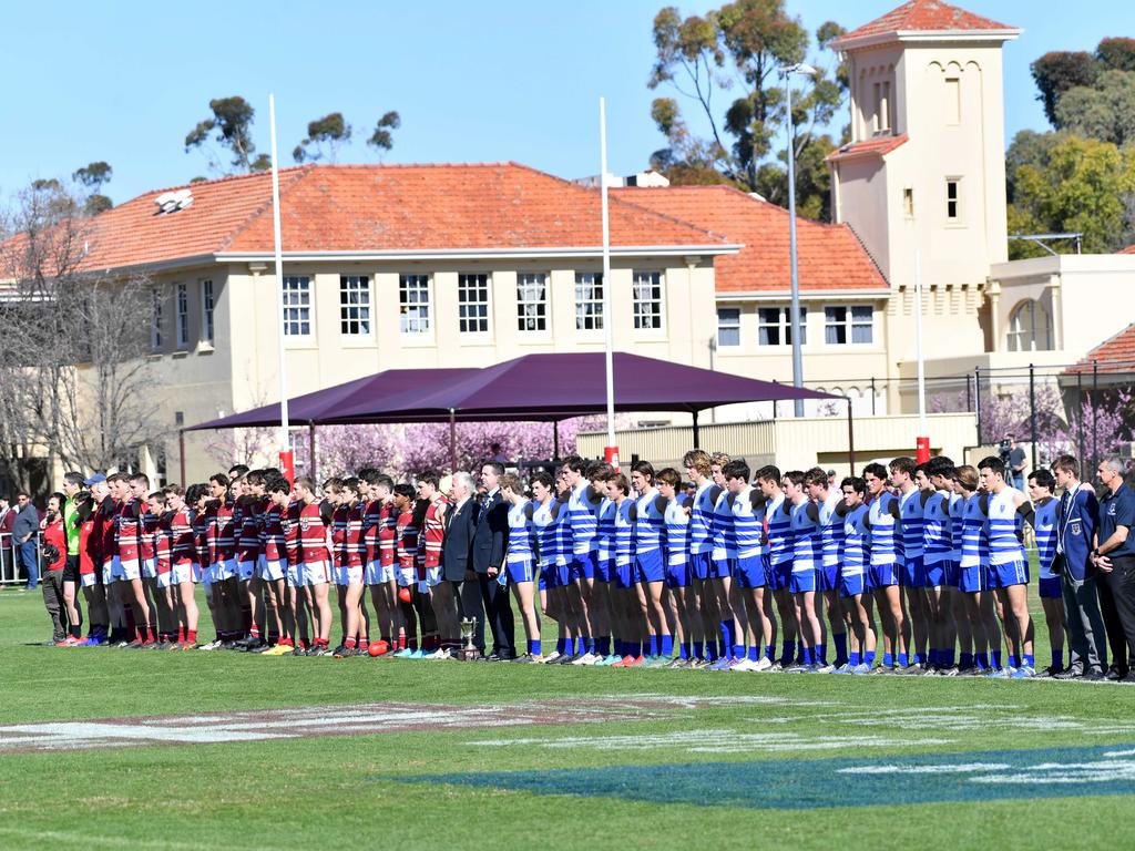 Prince Alfred College and St Peter’s College players linking arms before their intercol game. Picture: AAP/ Keryn Stevens.