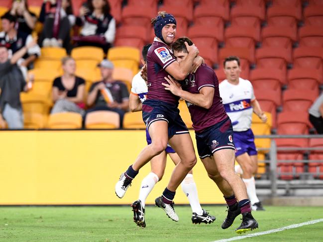 Tate McDermott (left) celebrates with James O'Connor during their days as Queensland teammates. Picture: Bradley Kanaris/Getty Images