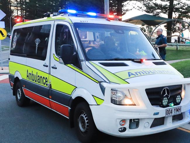 March 13, Rainbow Bay, Coolangatta, Gold Coast - Queensland Ambulance Officers interview witnesses to a mistaken report of a shark attack which turned out to be a self inflicted Surfing Fin Chop.Picture Scott Powick Newscorp