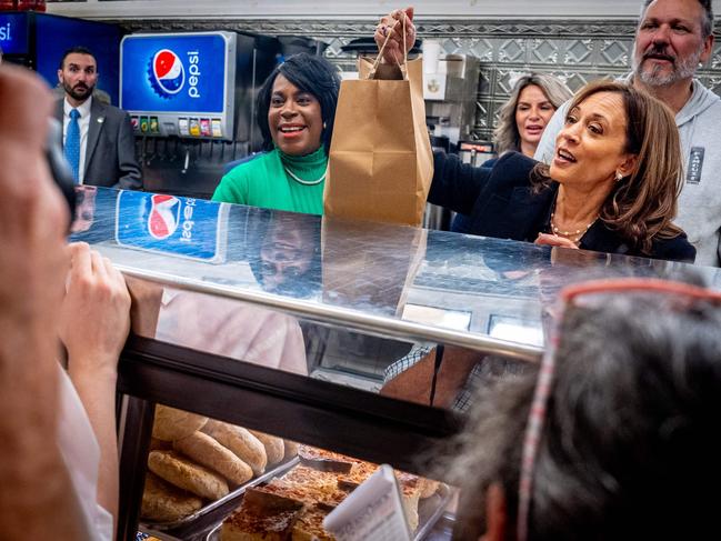 PHILADELPHIA, PENNSYLVANIA - OCTOBER 23: Democratic presidential nominee, Vice President Kamala Harris, accompanied by Philadelphia Mayor Cherelle Parker (L), picks up an order of food while visiting Famous 4th Street Delicatessen on October 23, 2024 in Philadelphia, Pennsylvania. With less than two weeks until Election Day, Harris is in Philadelphia to attend a CNN Town Hall with host Anderson Cooper.   Andrew Harnik/Getty Images/AFP (Photo by Andrew Harnik / GETTY IMAGES NORTH AMERICA / Getty Images via AFP)