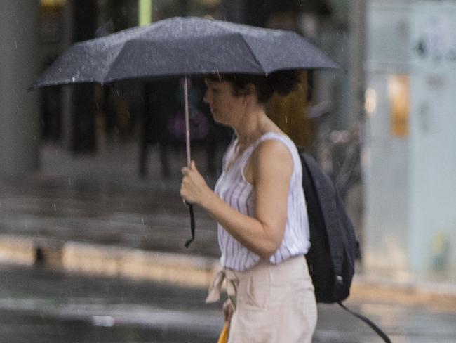 19/12/18 - People crossing Waymouth street, Adelaide in the rain