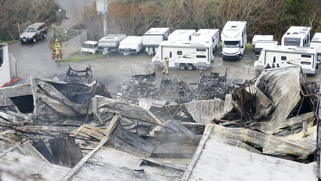 The building has collapsed and several million dollars worth of caravans and trailers have been destroyed. This is what remains this morning. Picture: MATT THOMPSON