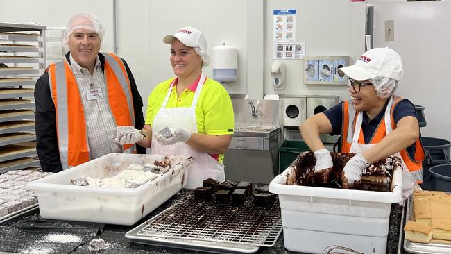 Costco Australia &amp; New Zealand Managing Director Patrick Noone with Nicole Hentzsch from Tallai and Eflinna Cross from Oxenford, who were making fresh lamingtons in the bakery at the Coomera store. Picture: Keith Woods.,