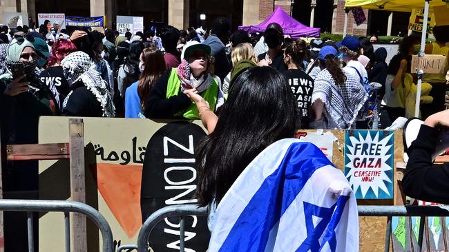 Pro-Israeli and pro-Palestinian supporters confront each other separated by metal barriers surrounding the encampment of pro-Palestinian demonstrators at the University of California in Los Angeles. Picture: AFP