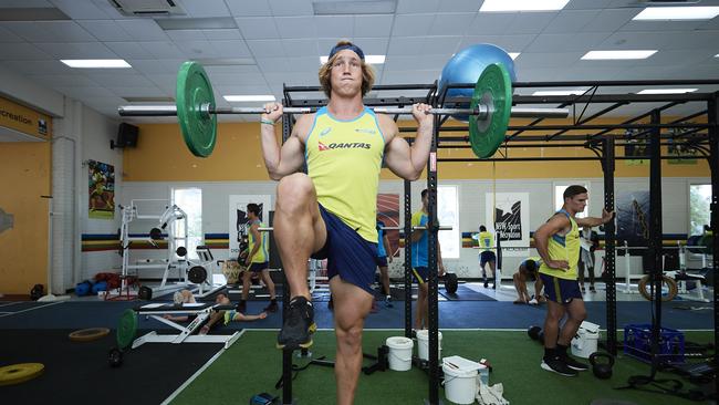 Jesse Parahi of the Australian sevens team works out in the gym in Sydney.