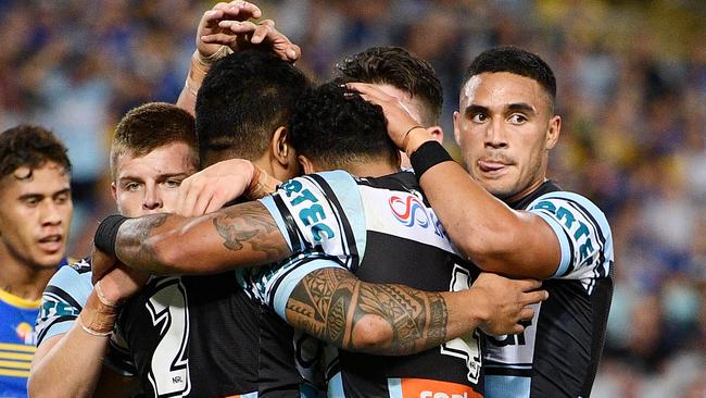 Sosaia Feki celebrates scoring a try with his Sharks teammates.