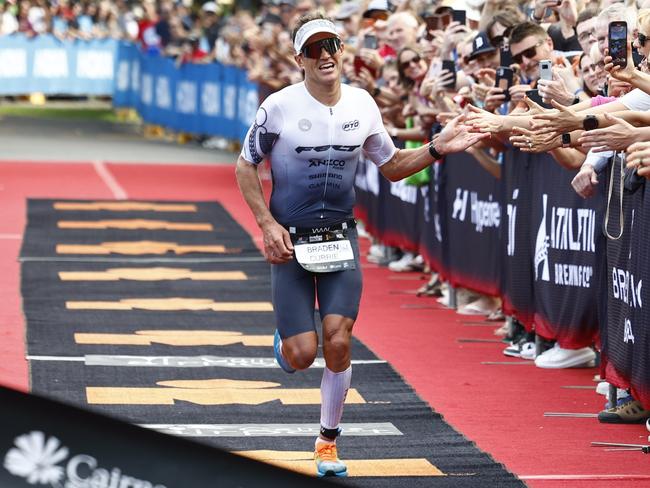 Braden Currie crosses the finish line on the Cairns Esplanade to win the Ironman Cairns Asia Pacific Championship. Picture: Brendan Radke