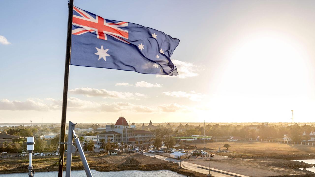 The Australian flag flying on board the HMAS Adelaide as the ship arrives in Nuku'alofa, Tonga. Picture: CPL Robert Whitmore / Australian Defence Force / AFP