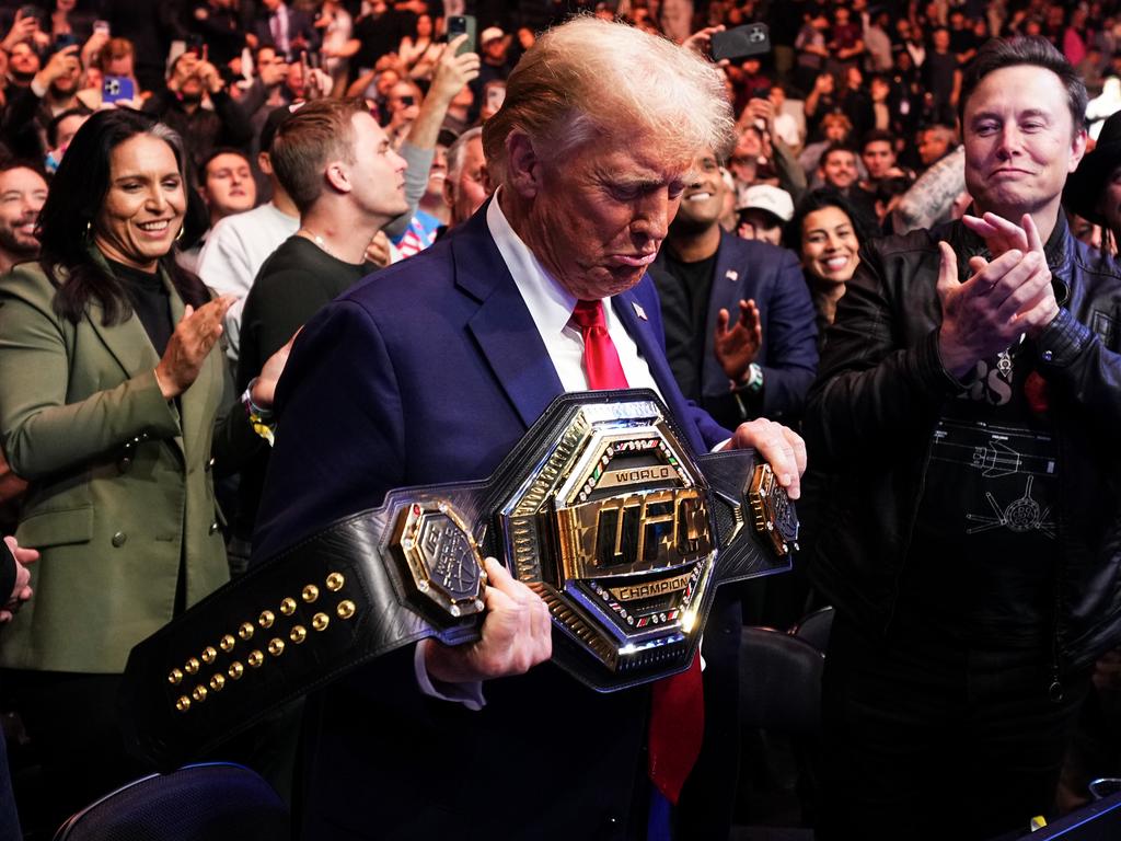 Tump holds Jon Jones' heavyweight belt, flanked by Tulsi Gabbard (L) and Elon Musk (R) at UFC 309 in New York in November. Picture: Getty Images