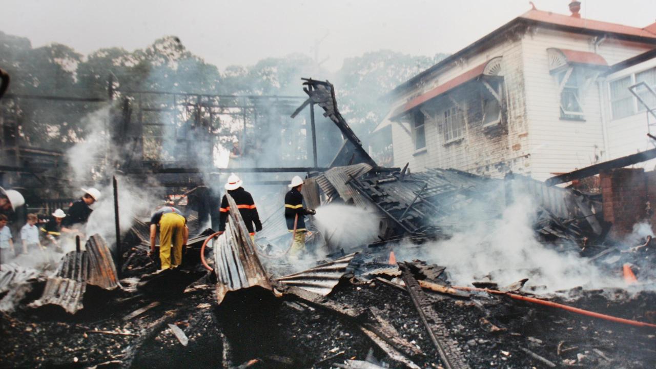 Emergency services workers sort through the ashes.