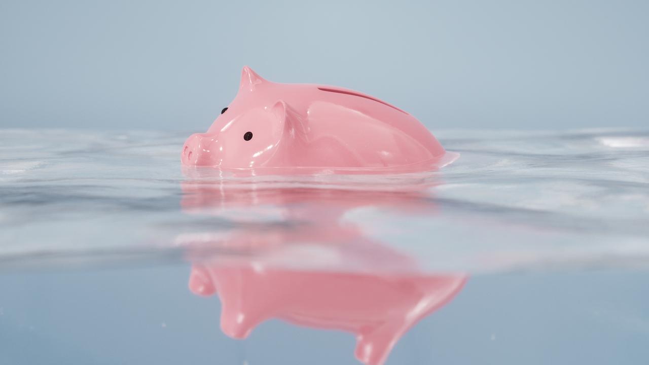 Sinking piggy bank in the water; recession household pressure generic