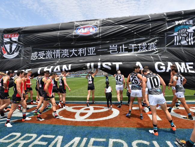 Players run through the banner during the Round 11 AFL match between the St Kilda Saints and Port Adelaide Power at Jiangwan Stadium, Shanghai, China in 2019. Picture: AAP