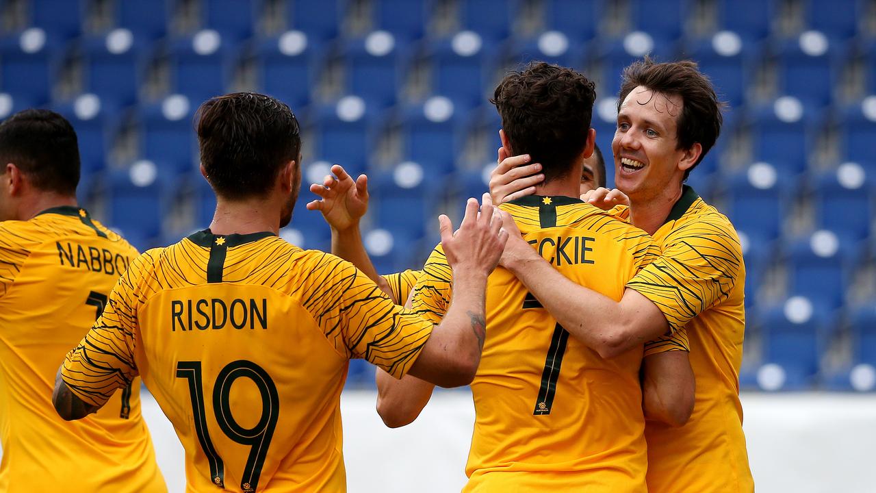 Soccerooos Mathew Leckie celebrates scoring a goal with team mates Josh Risdon and Robbie Kruse