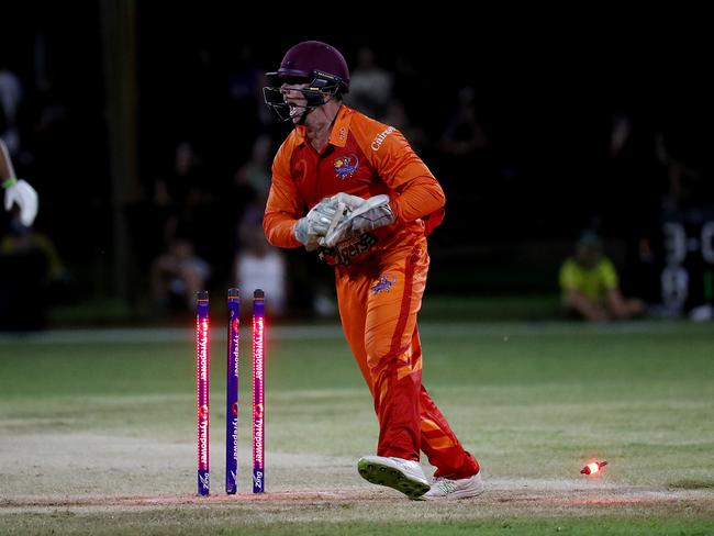 Barrier Reef Big Bash Game 1: Badgers v Hurricanes at Griffiths Park. Badgers' keeper Angus Warnock knocks the bails off to run out Hurricanes' Linden March. Picture: Stewart McLean