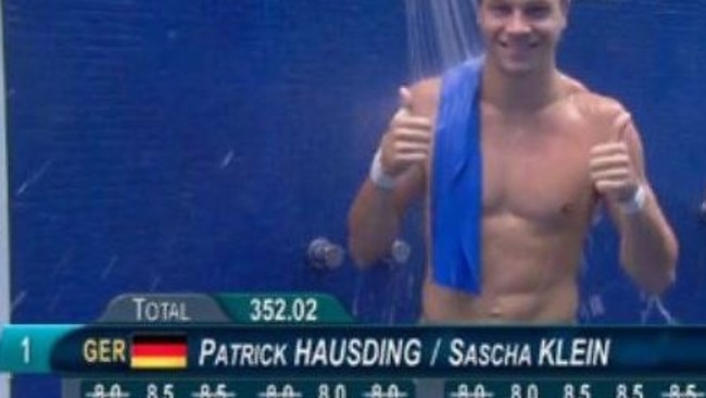 The scoring caption appears to make German diver Patrick Hausding naked as he salutes his score. Picture: Twitter / Erica Edstrom