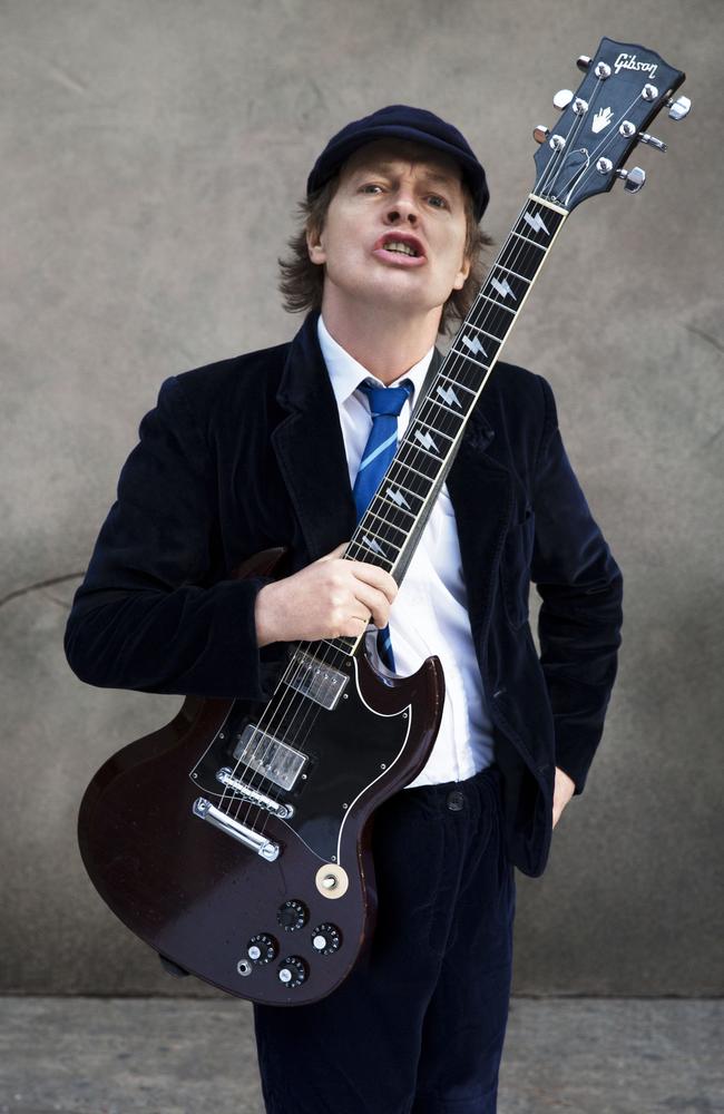 Still young ... Sporting his trademark school uniform, Angus Young honoured his brother’s wishes to keep going. Picture: Supplied.