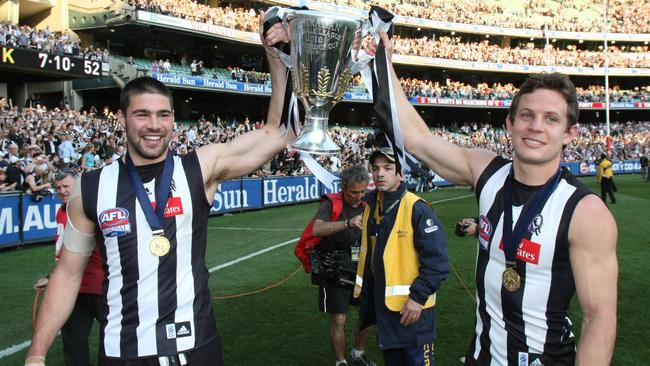 Chris Dawes celebrates Collingwood’s 2010 premiership with Luke Ball.