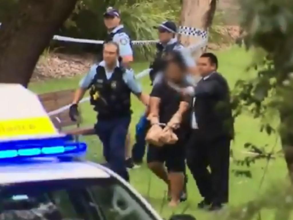The teenage boy is led away by police. Picture: 9 News