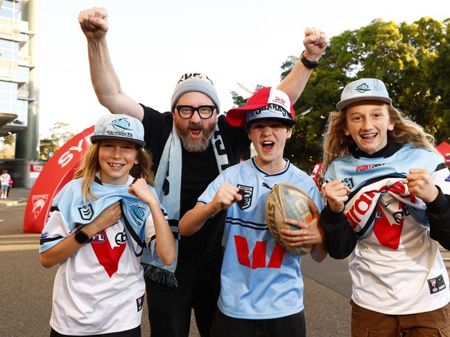 Sharks and Swans fans Luke Shanahan with his sons Walt, 11, (left) and Rudy, 13, (right) and their friend Max Munce, 12, at Moore Park for the Sharks Vs Cowboys NRL Finals game. Picture: Jonathan Ng