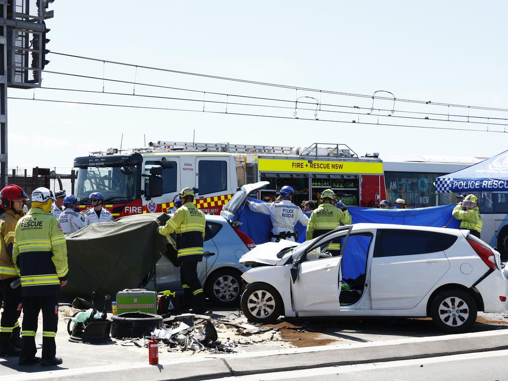 Emergency services personnel work on crash victims. Picture: Jonathan Ng