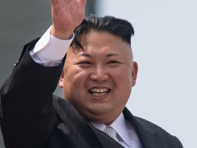 (FILES) This file photo taken on April 15, 2017 shows North Korean leader Kim Jong Un waving from a balcony of the Grand People's Study House following a military parade marking the 105th anniversary of the birth of late North Korean leader Kim Il-Sung in Pyongyang. - North Korean leader Kim Jong Un is "alive and well", a top security adviser to the South's President Moon Jae-in said late on April 26, 2020, downplaying rumours over Kim's health following his absence from a key anniversary. (Photo by ED JONES / AFP)