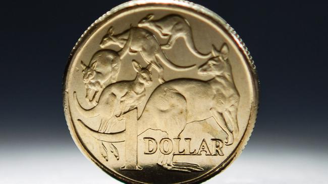 An Australian one-dollar coin is arranged for a photograph in Sydney, Australia, on Wednesday, April 17, 2013. Direct trading between the Australian dollar and yuan started on April 10. Photographer: Ian Waldie/Bloomberg