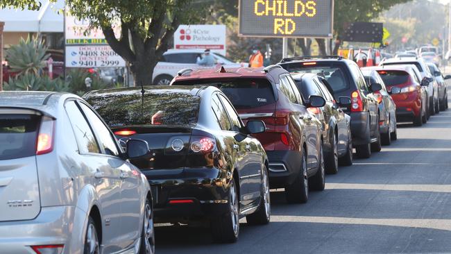 Cars line up on the street for COVID testing in Epping. Picture: David Crosling