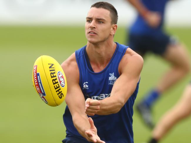 MELBOURNE, AUSTRALIA - JANUARY 18: Luke Davies-Uniacke of the Kangaroos handballs during a North Melbourne Kangaroos AFL training session at Arden Street Ground on January 18, 2021 in Melbourne, Australia. (Photo by Mike Owen/Getty Images)