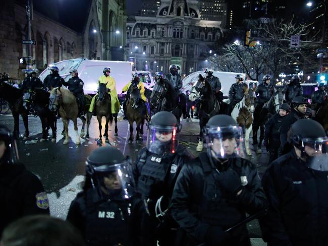 Police officers stand guard.