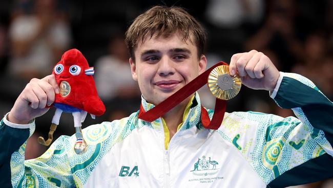 NANTERRE, FRANCE - SEPTEMBER 06: Gold medallist Callum Simpson of Team Australia poses for a photo on the podium during the Para Swimming Men's 100m Freestyle S8 medal ceremony on day nine of the Paris 2024 Summer Paralympic Games at Paris La Defense Arena on September 06, 2024 in Nanterre, France. (Photo by Sean M. Haffey/Getty Images)