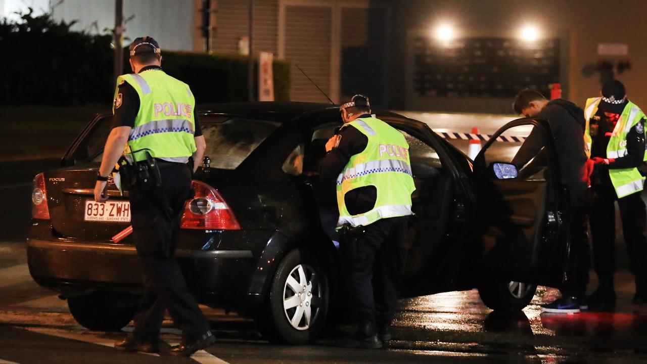 Queensland police officers arrest four males at 1am on QLD/NSW border crossing. Photo: Scott Powick