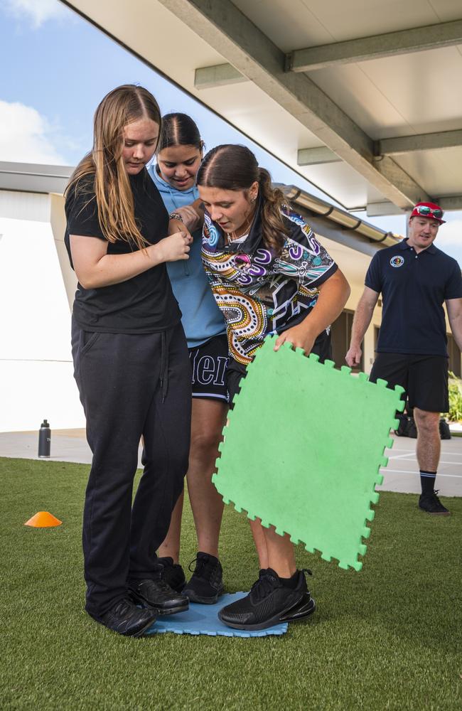 Project Booyah youth program participants (from left) Hanna, Kadisha and Holly work on a team building problem solving exercise in Toowoomba at Denise Kable Youth Services Centre, Tuesday, March 12, 2024. Picture: Kevin Farmer