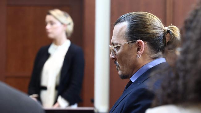 Amber Heard testifies as Johnny Depp looks on. Picture: AFP