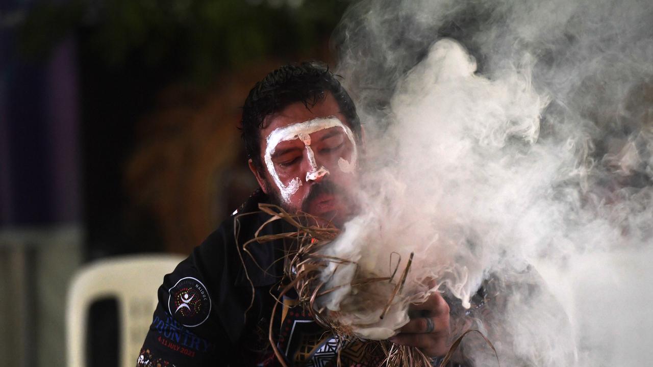 Trent Lee starts the fire for the smoking ceremony at Darwin Waterfront celebrations. Picture: (A)manda Parkinson