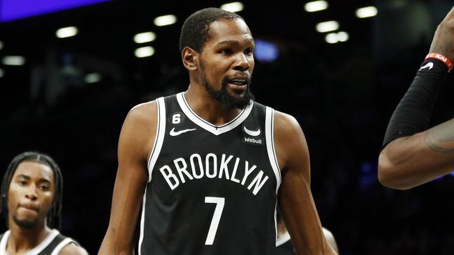 NEW YORK, NEW YORK - OCTOBER 27: Kevin Durant #7 talks with Ben Simmons #10 and Kyrie Irving #11 of the Brooklyn Nets during the second half against the Dallas Mavericks at Barclays Center on October 27, 2022 in the Brooklyn borough of New York City. The Mavericks won 129-125. NOTE TO USER: User expressly acknowledges and agrees that, by downloading and or using this photograph, User is consenting to the terms and conditions of the Getty Images License Agreement. (Photo by Sarah Stier/Getty Images)