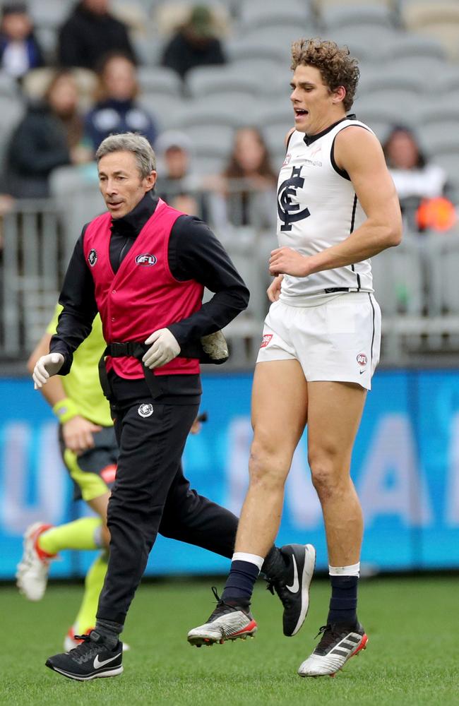 Curnow limps from the ground. Picture: AAP