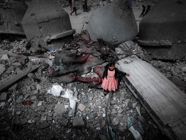 A Palestinian girl stands amid the ruins of the Al-Faruq Mosque, which was destroyed during Israeli bombardment on the southern Gaza Strip. Picture: Mohammed Abed/AFP