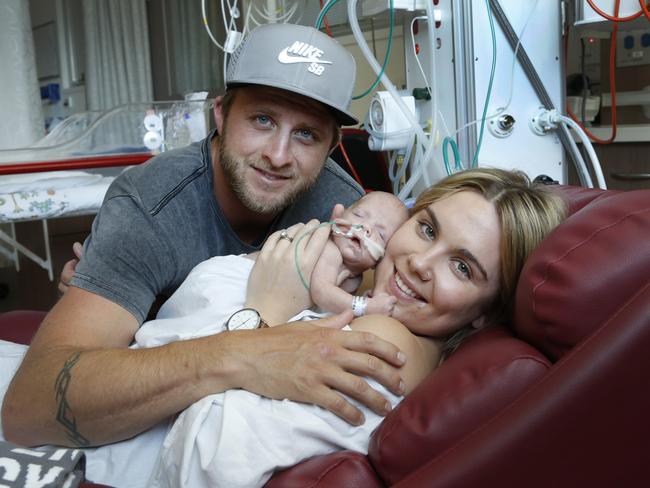 Premature baby Ziggy, 36 weeks, is cuddled by his parents Matt and Jessica Holland at the Royal Women's Hospital. Picture: David Caird