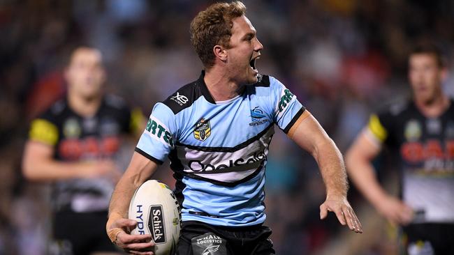 Matt Moylan celebrates after scoring a try for the Sharks.