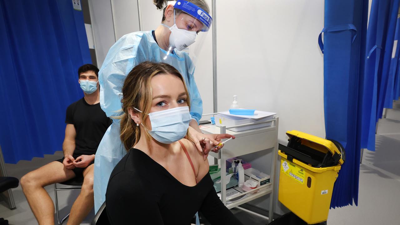 Claire Edler, 22, and Jacob Mahony, 31, getting their Covid-19 shots. The initial shots and the booster form a potent defence. Picture: David Caird