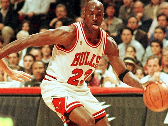 (FILES) In this file photo taken on June 4, 1997 former Chicago Bulls player Michael Jordan sticks out his tongue as he goes past Jeff Hornacek of the Utah Jazz during game two of the NBA Finals at the United Center in Chicago, IL. - Michael Jordan believes the Chicago Bulls 1990s NBA dynasty would have stayed together for at least one more season if team chiefs had backed coach Phil Jackson.  The retired legend made his comments in the last chapter of hit documentary "The Last Dance", saying he would have re-signed a one-year deal had management kept the team together, including Dennis Rodman, Scottie Pippen and Jackson. (Photo by VINCENT LAFORET / AFP)