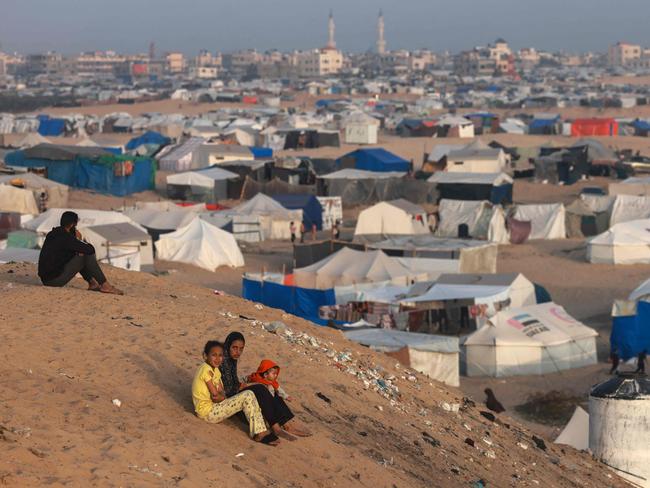 Palestinian children sit on a hill next to tents housing the displaced in Rafah in the southern Gaza Strip. Picture: AFP