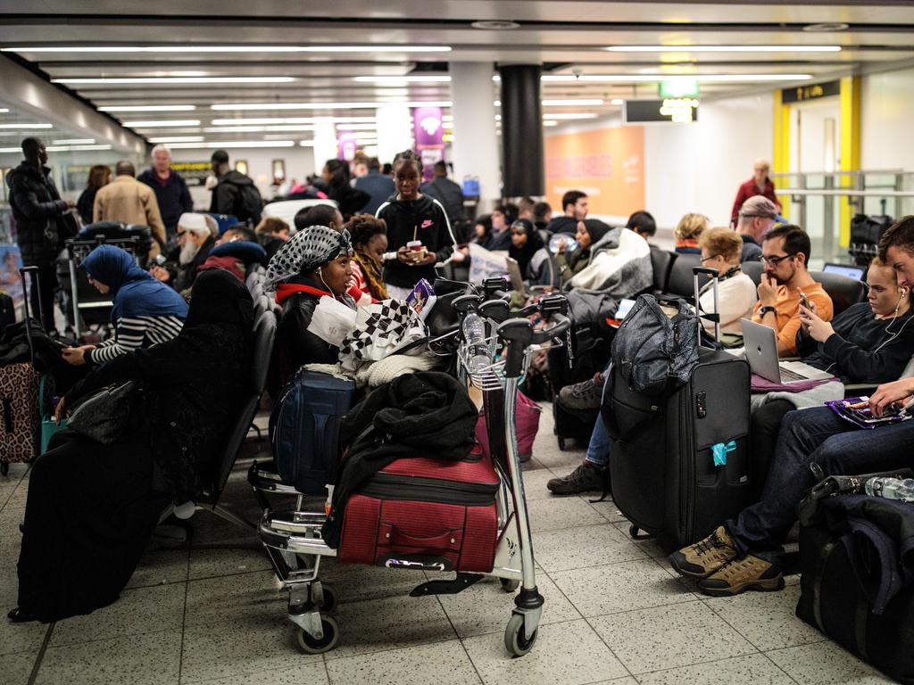 Passengers wait with their luggage in the South Terminal building at London Gatwick Airport after flights resumed today. Picture: Getty