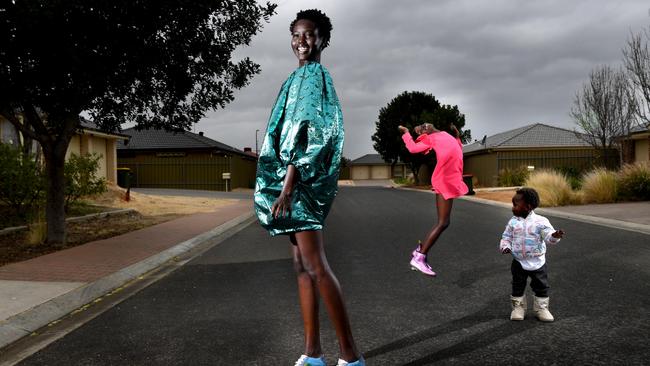 Adelaide model Adut in the street of her northern suburbs home with her sisters Akuol and Yar. Picture: Tricia Watkinson