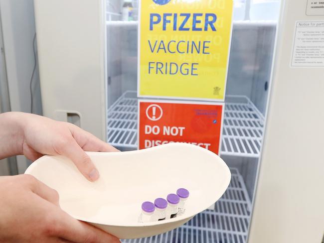 BRISBANE, AUSTRALIA - AUGUST 11:  Pharmacy Lead Sarah Spann is seen with Pfizer vials on opening day of the COVID-19 vaccination hub at Brisbane Convention and Exhibition Centre on August 11, 2021 in Brisbane, Australia. The vaccination hub will provide the Pfizer vaccine and second dose of AstraZeneca to individuals with bookings as Queensland opens the vaccine registration list state-wide to anyone over 16. The Australian government says 70% of eligible Australians must be fully vaccinated before the country reopens. (Photo by Tara Croser - Pool/Getty Images)