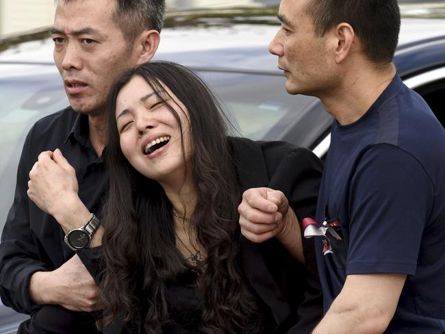 Peter Wang’s mother Hui cries as she is helped into a car after the memorial service for her 15-year-old son at Kraeer Funeral Home in Coral Springs, Florida. Picture: Taimy Alvarez/South Florida Sun-Sentinel via AP